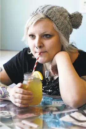  ?? Photos by Michael Short / Special to The Chronicle ?? Hanna Eichman of Oakland enjoys an Arnold Palmer served at Saturn Cafe in Berkeley with a paper straw, which is more costly than a plastic one.