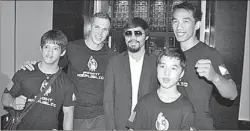  ?? GILBERT CHOY / FOR CHINA DAILY ?? From left: The founders of Fight Republic Gym, Ryan Willis, Rory van den Berg and Jerson Estoro, along with one of their students, pose with boxing legend Manny Pacquiao.