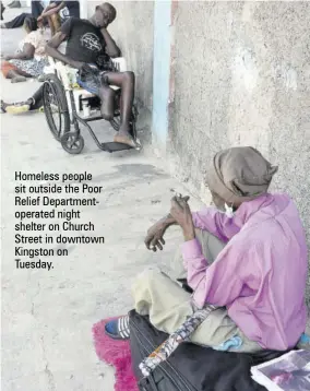  ??  ?? Homeless people sit outside the Poor Relief Department­operated night shelter on Church Street in downtown Kingston on Tuesday.