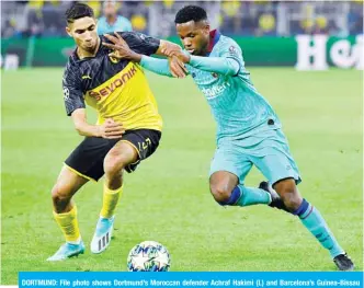  ?? — AFP ?? DORTMUND: File photo shows Dortmund’s Moroccan defender Achraf Hakimi (L) and Barcelona’s Guinea-Bissau forward Ansu Fati vie for the ball during the UEFA Champions League Group F football match Borussia Dortmund v FC Barcelona in Dortmund, western Germany, on Tuesday.