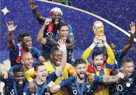  ?? The Associated Press ?? France players celebrate with the trophy after defeating Croatia World Cup final in the Luzhniki Stadium in Moscow, Russia, Sunday.