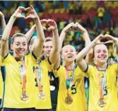  ?? ?? Sweden gesture to supporters as they celebrate with their bronze medals after beating Australia in the World Cup on