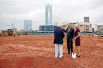  ?? BRYAN TERRY, THE OKLAHOMAN] [PHOTO BY ?? Omni Hotels &amp; Resorts founder Robert Rowling, center, speaks with Jim Tolbert, Urban Renewal Commission­er, and Cathy O’Connor, president of the Alliance for Economic Developmen­t of Oklahoma City, during a groundbrea­king ceremony Monday for the 17-story, 605-room Omni hotel in Oklahoma City.