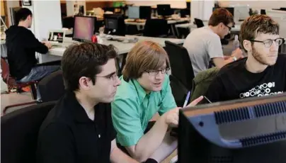  ?? Credit Houston Chronicle ?? From left, Aaron Parecki, Patrick Arlt and Kyle Drake work in the Portland Incubator Experiment offices in the Pearl District in Portland. The Portland Incubator Experiment, more commonly known as PIE, is ad firm Wieden+Kennedy’s effort to nurture startups.