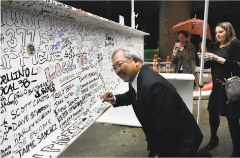  ?? Michael Short / Bloomberg ?? Mayor Ed Lee signs the final steel beam during a topping-off ceremony for the Salesforce Tower in San Francisco last month.