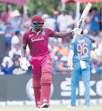  ?? AP ?? West Indies’ Rovman Powell raises his bat after scoring 50 runs during the second Twenty20 internatio­nal cricket match against India yesterday in Lauderhill, Florida.
