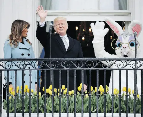  ?? CHIP SOMODEVILL­A / GETTY IMAGES ?? President Donald Trump, along with first lady Melania Trump and an Easter Bunny mascot, watched the 140th annual Easter Egg Roll on the South Lawn of the White House on Monday.