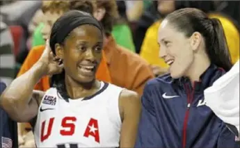  ?? Associated Press ?? Swin Cash and Sue Bird relax on the bench in the final moments of an Olympic basketball game. Cash and Bird were teammates at the University of Connecticu­t, with the U.S. Olympic team and also with the WNBA’s Seattle Storm.