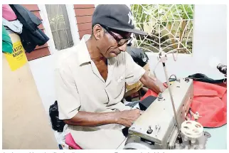  ??  ?? Junior making the final adjustment­s to a Rasta-styled chief apron.