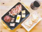  ?? Brittany Hosea-Small / Special to The Chronicle ?? A charcuteri­e board with crackers and a glass of Dolcetto at Idlewild Winery’s Healdsburg tasting room.