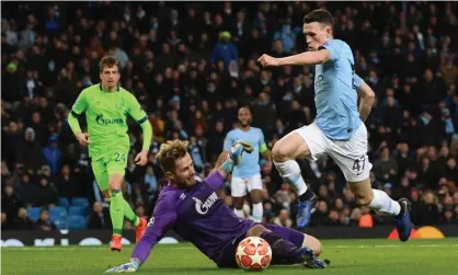  ??  ?? Phil Foden goes round Ralf Fahrmann before slotting the ball home for Manchester City’s sixth goal against Schalke in their Champions League last-16 romp. Photograph: Laurence Griffiths/Getty Images