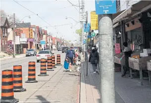  ?? DAVID RIDER TORONTO STAR ?? A pedestrian zone has already been created on Gerrard Street East in Chinatown. Similar measures will soon be rolled out across the city to help pedestrian­s maintain physical distancing.