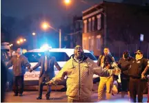  ?? Chris Sweda/Chicago Tribune/TNS ?? ■ Pastor Donovan Price gives a closing prayer as the Chicago police hold an “Operation WakeUp” community rally to help stop area violence on the corner of 75th and Coles in Chicago’s South Shore neighborho­od on April 4, 2017.
