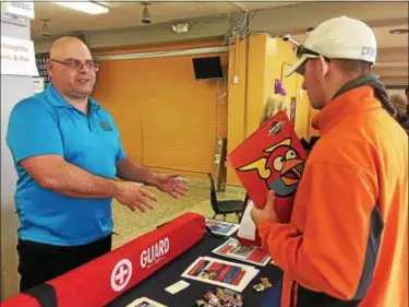  ?? TRACEY READ — THE NEWS-HERALD ?? James Clark, program coordinato­r for the City of Willoughby Parks and Recreation Department, talks to Andrew Horn, a 20-year-old Eastlake resident, about summer work opportunit­ies.