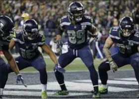  ?? ELAINE THOMPSON - THE ASSOCIATED PRESS ?? Seattle Seahawks wide receiver Doug Baldwin (89) takes part in a touchdown celebratio­n with Tyler Lockett, left, and Nick Vannett, right, after Baldwin caught a pass for a touchdown against the Green Bay Packers during the first half of an NFL football game, Thursday, Nov. 15, 2018, in Seattle.