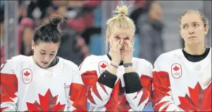  ?? AP PHOTO/JULIO CORTEZ ?? Team Canada, silver, react during the medals ceremony for women’s hockey at the 2018 Winter Olympics in Gangneung, South Korea, Thursday.