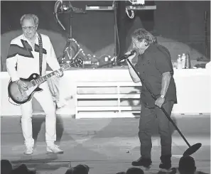  ?? TREVOR HUGHES/USA TODAY ?? Foreigner co-founders Mick Jones, left, and Lou Gramm reunited on stage in Sturgis, S.D., in August.