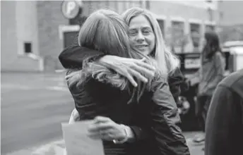  ?? Joe Amon, The Denver Post ?? Emily Murray, right, is hugged by her foster mom, Jennifer Pennell, as they celebrate Emily’s 20th birthday on May 20 in Boulder. Emily was also joined by her foster dad, Marcus Pennell, and the Pennels’ 12-year-old daughter, Amelia.