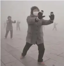  ??  ?? Retirees practice Taichi during their morning exercise on a hazy day in Fuyang city, in central China’s Anhui province.