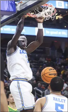  ?? CHASE STEVENS — THE ASSOCIATED PRESS ?? UCLA forward Adem Bona dunks against Oregon during the first half of a game in the Pac-12 tournament quarterfin­als on Friday in Las Vegas.