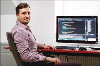  ??  ?? In this July 25, 2017 photo, Vilem Prochazka, an employee of Boston-based software company KangoGift, poses for a photo while sitting at his computer at his home in Kolin, Czech Republic. At some small businesses, the traditiona­l chat
around the...