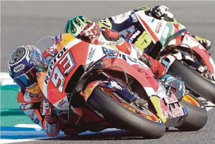  ?? EPA PIC ?? Marc Marquez (left) of Repsol Honda Team leads Cal Crutchlow of LCR Honda Castrol to win the Japan MotoGP and World Champion title yesterday.