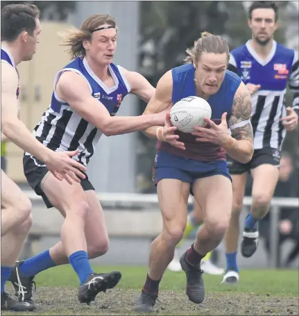  ??  ?? CHASE: Minyip-murtoa’s Jake Ballagh tackles Horsham’s Deek Roberts. Minyip-murtoa continued dominant home and away campaign with an 18.12 (120) to 6.8 (44) thumping of the reigning premier.
Picture: PAUL CARRACHER its