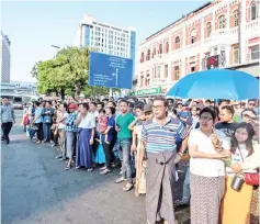  ?? — AFP photo ?? A large crowd of Myanmar onlookers viewing the filming of the movie ‘Line Walker 2’ near a pagoda in Yangon, on Tuesday.