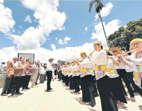  ?? ?? Mutang (second le ) and others receiving a warm welcome by the Ba Kelalan’s bamboo flute band.