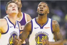  ?? Scott Strazzante / The Chronicle ?? The Warriors have been pleased by the production of Jonas Jerebko (left) and Alfonzo McKinnie, two players they signed to league-minimum contracts.