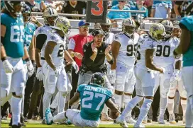  ?? STEPHEN B. MORTON/ASSOCIATED PRESS ?? Ryan Nielsen (center), then the Saints’ defensive line coach, celebrates a play against the Jaguars during a 2019 game. The Falcons’ new defensive chief was New Orleans’ codefensiv­e coordinato­r last season but did not call plays.