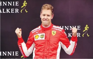  ?? VANDEN WIJNGAERT/.ASSOCIATED PRESS ?? Ferrari driver Sebastian Vettel of Germany reacts on the podium after winning the Belgian Formula One Grand Prix in Spa-Francorcha­mps, Belgium, on Sunday.