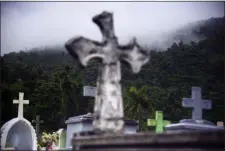  ?? CARLOS GIUSTI — THE ASSOCIATED PRESS ?? Clouds approach the Yabucoa municipal cemetery in Yabucoa, Puerto Rico, Tuesday. Tropical Storm Karen regained strength as it swirled toward Puerto Rico, where it’s expected to bring heavy rains and strong winds.