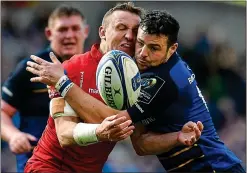  ??  ?? CLASH: Leinster’s Robbie Henshaw goes up against Hadleigh Parkes of Scarlets yesterday
