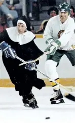  ?? POSTMEDIA NETWORK FILES ?? Father Ernie Smith tries on a new habit against Lou Halat at a past charity game by the Flying Fathers, a group of hockeyplay­ing priests who criss-crossed Canada for 45 years for charity games.