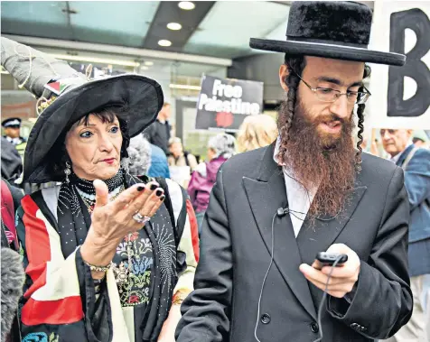  ??  ?? A ‘Labour Against the Witch-hunt’ protester stands next to a member of the Jewish community, above, yesterday; Jeremy Corbyn, left, and Peter Willsman, far left, arrive for the meeting of the Labour NEC