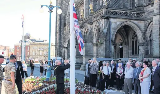 ??  ?? ●●The Deputy Mayor of Rochdale, Coun Billy Sheerin, raises the flag outside the Town Hall to celebrate Armed Forces Day