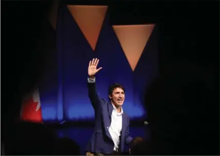  ?? DAVID BEBEE, RECORD STAFF ?? Prime Minister Justin Trudeau greets the crowd inside Hagey Hall theatre while giving the opening address at Hack the North Friday.