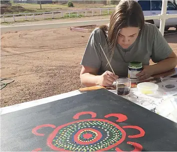  ?? ?? Montana McStay at work on one of her cultural art pieces.