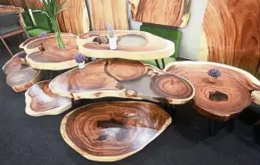  ??  ?? A set of coffee tables designed by Art of Tree made from salvaged tree parts.