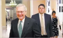  ?? Alex Brandon ?? Senate Majority Leader Mitch Mcconnell of Kentucky, left, walks out of his office Wednesday on Capitol Hill.