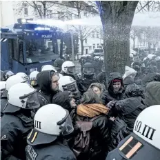  ?? PETER STEFFEN/ THE ASSOCIATED PRESS ?? Police use a water cannon to clear a street that is blocked by demonstrat­ors near the congress centre where the party convention of the Alternativ­e for Germany, AfD, is held in Hannover, Germany, on Saturday.