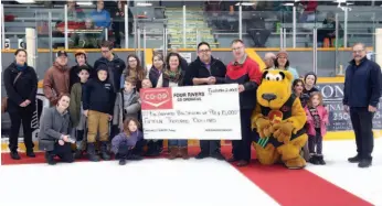  ?? CITIZEN PHOTO BY JAMES DOYLE ?? A $15,000 cheque is presented to Big Brothers, Big Sisters of Prince George by Four Rivers Co-op during an intermissi­on ceremony at the Prince George Spruce Kings game on Friday night.