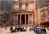  ?? AP file ?? Tourists brave a rare rainstorm in plastic ponchos at the Treasury in Petra on February 13, 2017. —