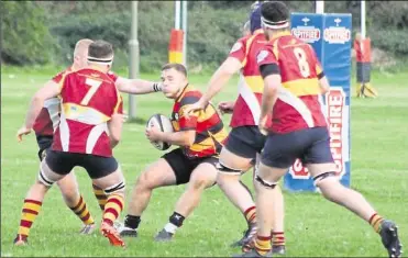  ?? ?? Ashford’s Will Blyth tries to evade the Dartfordia­ns forwards on Saturday