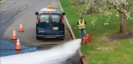  ?? MICHAEL WALKER/TRENTONWAT­ERWORKS ?? A TrentonWat­erWorks water-distributi­on system technician tests a fire hydrant in Hamilton Township.