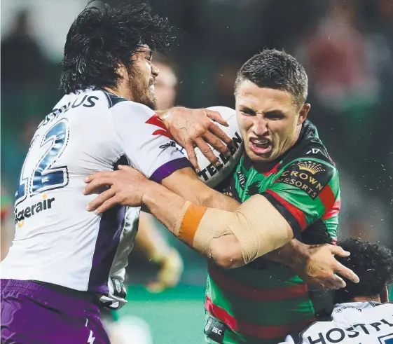  ??  ?? Rabbitohs forward Sam Burgess charges at Melbourne defenders but his side couldn’t make inroads against the NRL leaders. Picture: MATT KING