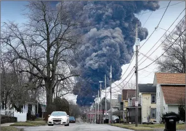  ?? (File Photo/AP/Gene J. Puskar) ?? A black plume rises over East Palestine, Ohio, on Feb. 6 as a result of a controlled detonation of a portion of derailed Norfolk Southern trains. Stories circulatin­g online incorrectl­y claim a video of a purple cloud looming over a street as a car drives underneath shows East Palestine after the derailment and intentiona­l burning of some of the hazardous chemicals on board.
