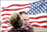  ?? AP/LINDSEY BAUMAN ?? Army Pvt. Randy Donovan is hugged by his mother, Twila Donovan, upon arriving at the Crossroads Christian Church in Hutchinson, Kan., for a welcome home party in April. Donovan was injured by a blast in Afghanista­n in November 2011. His injuries...