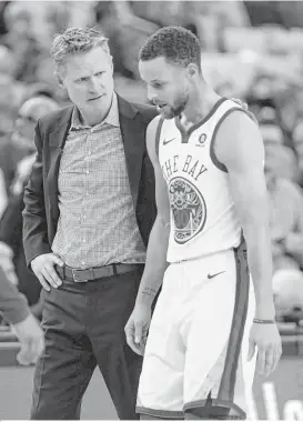  ?? Carlos Avila Gonzalez / San Francisco Chronicle ?? Warriors coach Steve Kerr checks on Stephen Curry as he leaves Thursday’s game against the Spurs after rolling his right ankle. The Warriors are calling the injury a ‘tweak’ and Curry may miss a game or two.